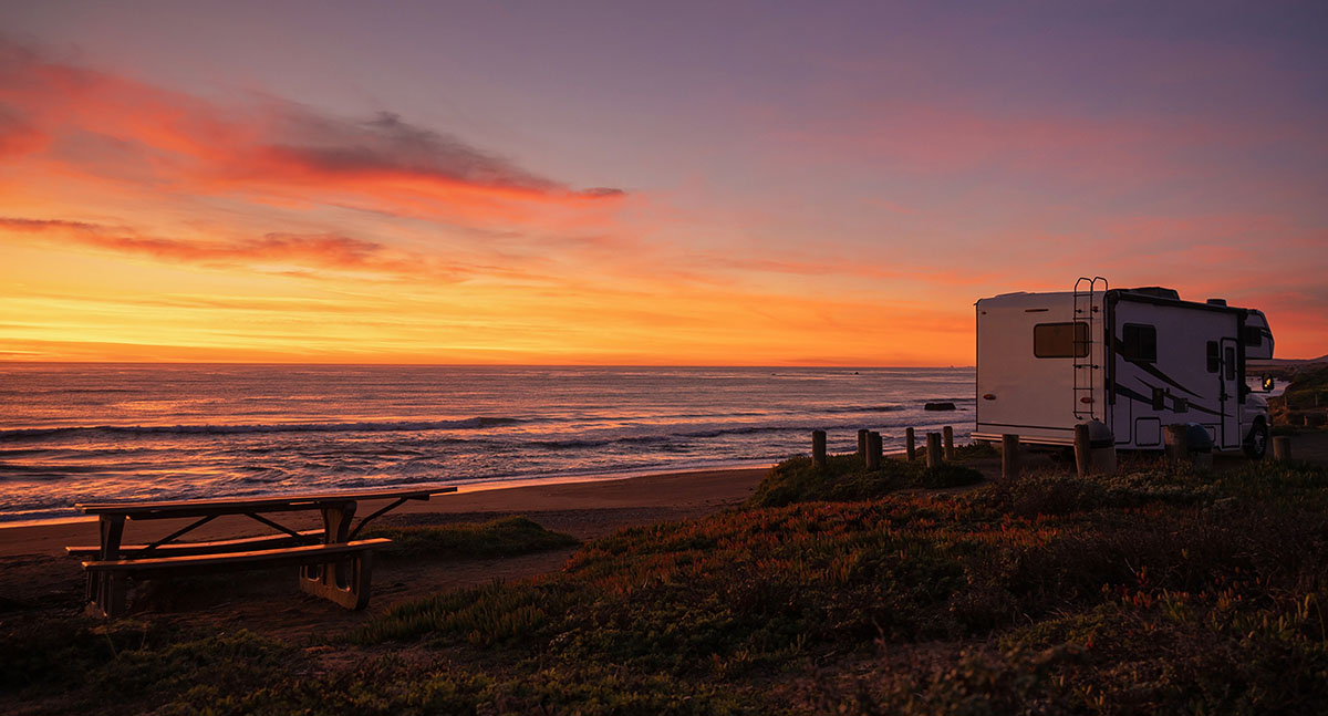 Class C motorhome camping at a scenic California beach after an RV inspection 