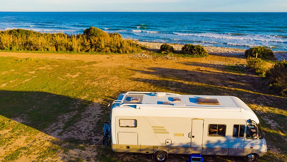 Caravan parked by the beach after thorough RV Inspection services