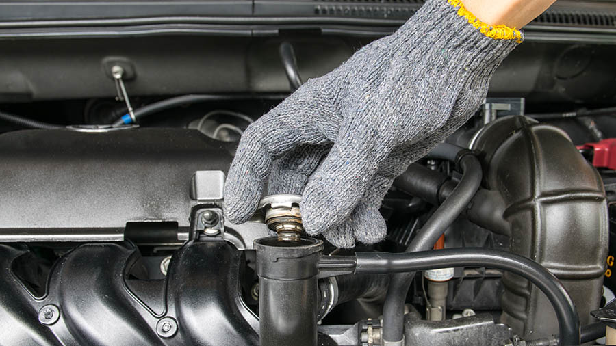 Checking the engine fluids while performing RV inspection services 